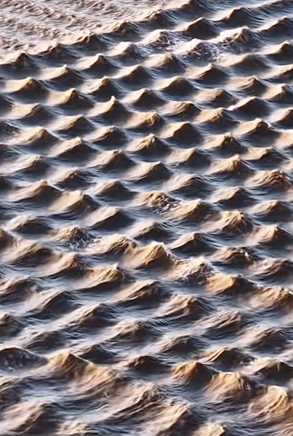 Intersecting ocean waves forming a field of repeated localized peaks